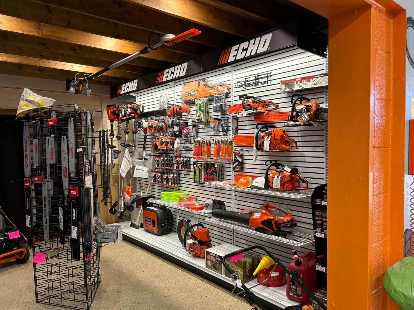 ECHO branded product wall with chainsaws, trimmers, and accessories under the ECHO banner
